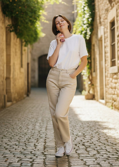 Paradime Enterprise LLC Aubusson Love Potion No.03 Raspberry Kiss perfume held by a woman in a sunny stone alleyway.