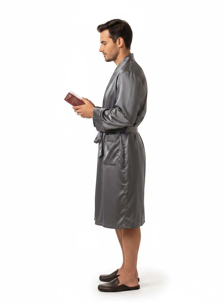 Paradime Enterprise LLC man wearing a grey satin robe while holding a book, side profile view.
