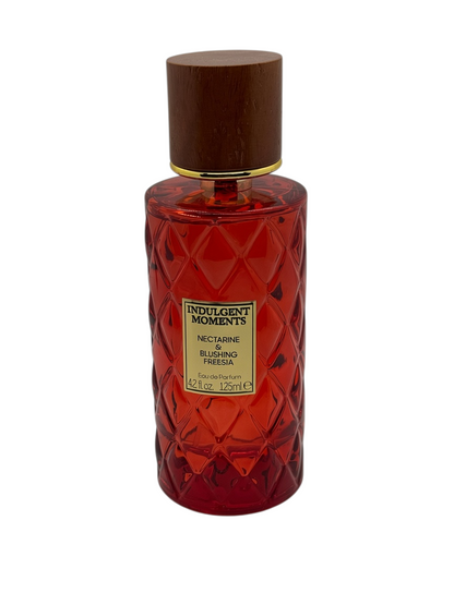 Paradime Enterprise LLC Indulgent Moments Lavender & Honeysuckle EDP in a purple quilted glass bottle with a wood cap.