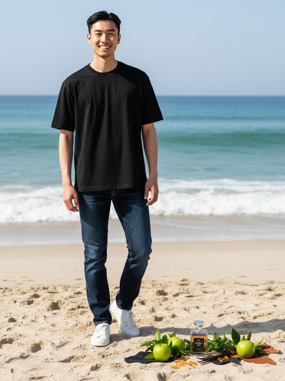 Paradime Enterprise LLC Manos De Fuego Macho Man EDT fragrance bottle on a beach with a man in a black t-shirt