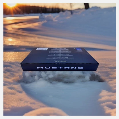 Paradime Enterprise LLC Mustang 4-piece fragrance gift set box resting on snowy ground at sunset