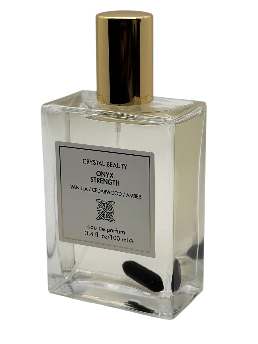 Paradime Enterprise LLC Crystal Beauty Onyx Strength perfume in a glass bottle with a gold cap and black onyx stone.