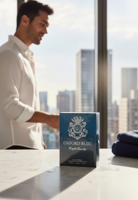 Paradime Enterprise LLC English Laundry Oxford Bleu Eau de Parfum bottle on a marble counter with a man in the background