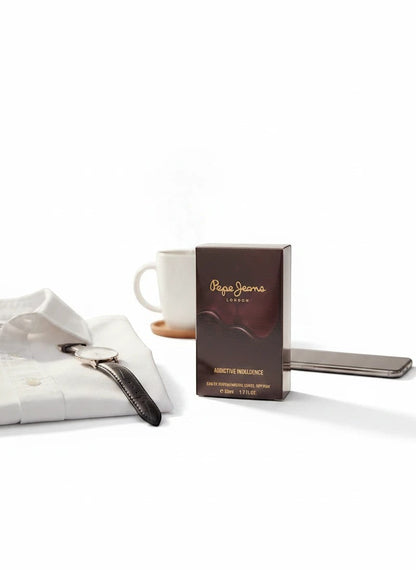 Paradime Enterprise LLC Pepe Jeans Addictive Indulgence EDP fragrance box next to a white shirt and coffee mug