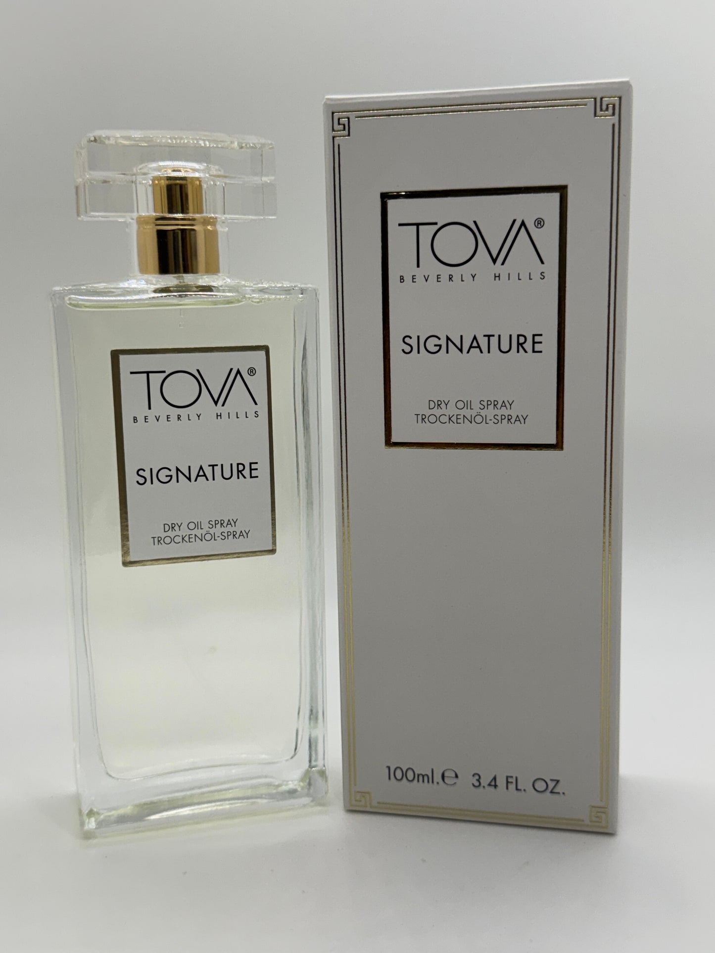 Paradime Enterprise LLC Tova Signature dry oil spray bottle and white packaging box on a white background.